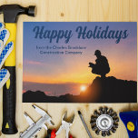 Happy Holidays Custom Construction Company Sunset Postcard<br><div class="desc">A construction worker crouches in front of a beautiful sunset on this lovely Happy Holidays postcard. A cute personalized construction company or home builder business Christmas postcard.</div>