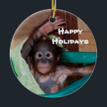 Happy Smiling Animal Baby Holiday Ceramic Ornament<br><div class="desc">Here's a holiday ornament that helps to save orphaned wildlife. The orangutan baby on this ornament is one of hundreds of orphans on the island of Borneo. The artist donates 100% of all profits from the sale of this item to support the Care Centre where these babies are cared for...</div>