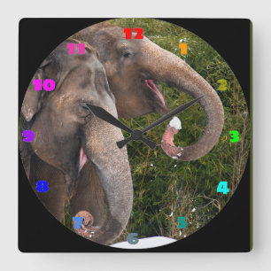 Happy smiling cute elephants playing in the snow. square wall clock