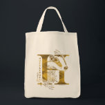Harry Potter | Aguamenti HUFFLEPUFF™ Graphic Tote Bag<br><div class="desc">Check out this Hufflepuff graphic based on the Aguamenti water-making spell. This features a yellow badger poking it's head through a giant letter "H" and the name "Hufflepuff" written below.</div>