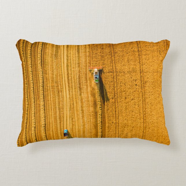 Harvester machine working in field. Combine harves Accent Pillow (Front)