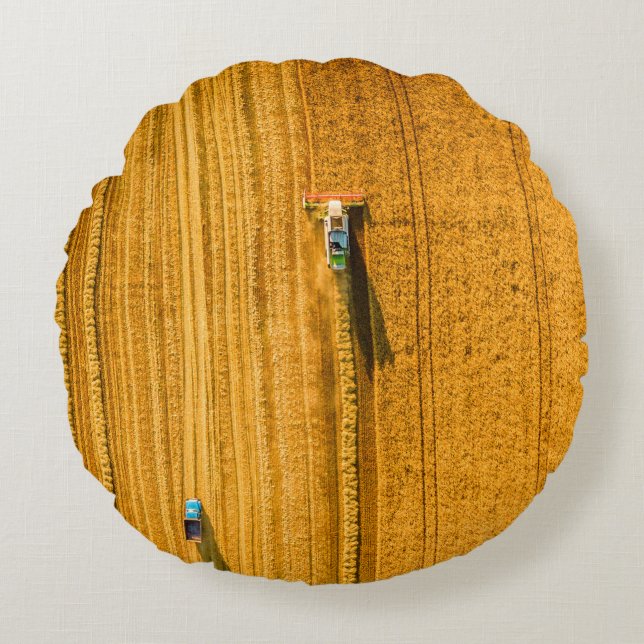 Harvester machine working in field. Combine harves Round Pillow (Front)