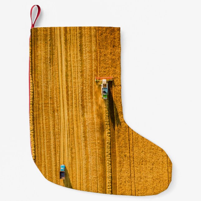Harvester machine working in field. Combine harves Small Christmas Stocking (Front)