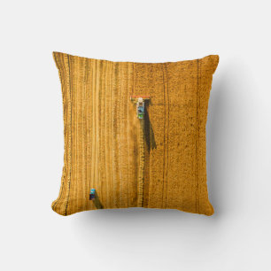 Harvester machine working in field. Combine harves Throw Pillow