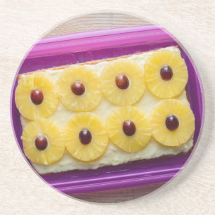 Hawaii slices with pineapple on rustic wood coaster