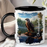 Hawk by Mountain Lake Reflection Mug<br><div class="desc">Enjoy your favourite beverage with the Hawk by Mountain Lake Reflection Mug. This captivating mug features a detailed image of a hawk perched on a rock by a serene mountain lake, with the clear water reflecting the majestic bird and the surrounding wilderness. Customized with your name, it adds a unique...</div>