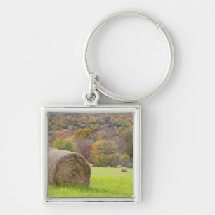 Hay bales and fall foliage on farm, keychain