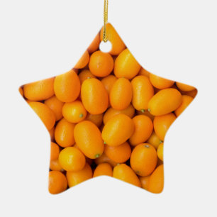 Heap of orange kumquats in cardboard box ceramic ornament