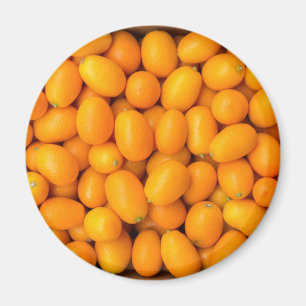 Heap of orange kumquats in cardboard box magnet