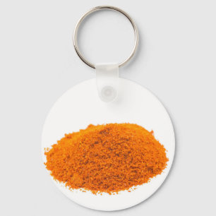 Heap of spice cayenne pepper powder on white keychain