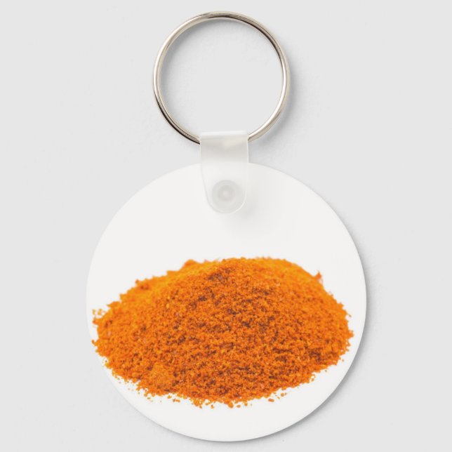Heap of spice cayenne pepper powder on white keychain (Front)
