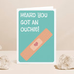 Heard You Got An Ouchie! Get Well Soon Card<br><div class="desc">Send a get well soon greeting with this fun "Heard you got an ouchie" card. The design features a solitary band-aid with a little heart and sun typography wording.</div>