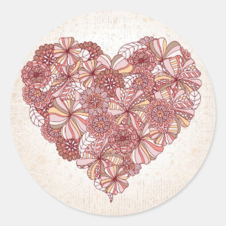 Heart made of hand drawn flowers classic round sticker