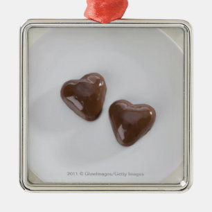 Heart shaped chocolate candies on a plate metal ornament