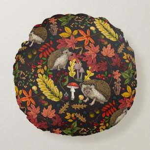 Hedgehogs and autumn forest flora on black round pillow