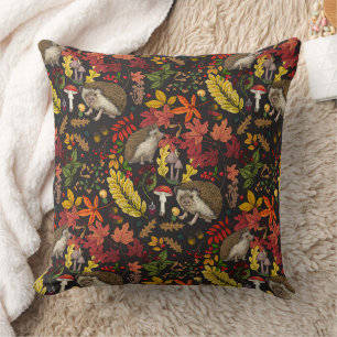 Hedgehogs and autumn forest flora on black throw pillow