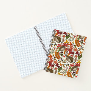 Hedgehogs and autumn forest flora on ivory notebook