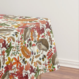 Hedgehogs and autumn forest flora on ivory tablecloth