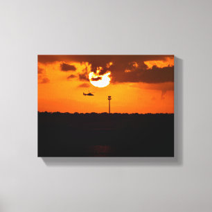 Helicopter flying at sunset canvas print