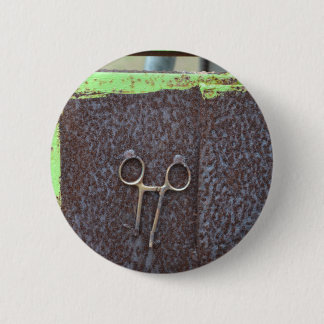 hemostat rusting metal grunge work 2 inch round button