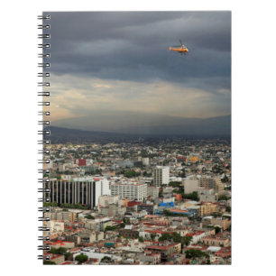 High Angle View Of Cityscape Against Cloudy Sky Notebook