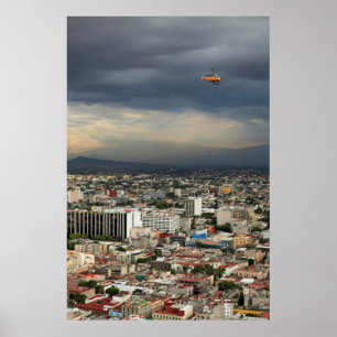 High Angle View Of Cityscape Against Cloudy Sky Poster