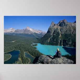 Hiker overlooking turquoise-colored Lake Poster