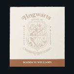 HOGWARTS™ School of Witchcraft and Wizardry Crest Notepad<br><div class="desc">Honor the legacy of the wizarding world with this timeless Hogwarts™ School of Witchcraft & Wizardry crest design. Featuring the iconic four-house shield — lion, serpent, badger, and eagle — this elegant artwork represents the unity and tradition of Gryffindor™, Slytherin™, Hufflepuff™, and Ravenclaw™. Rendered in a refined, vintage-inspired line style,...</div>