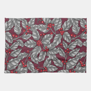 Holly berry, grey leaves on dark red kitchen towel