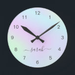 Holographic Girly Modern Elegant Script Name Round Clock<br><div class="desc">Modern wall clock featuring your name in an elegant handwritten script with swashes over a colourful holographic gradient in pastel pink, purple, blue and green. This stylish and feminine wall clock is great for a girly girl and makes a great gift for her.</div>