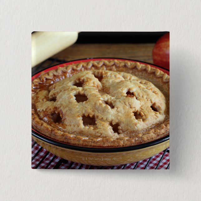 Home baked apple pie on cooling rack with apple 2 inch square button (Front)