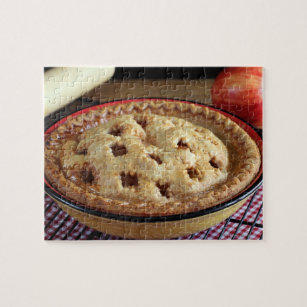 Home baked apple pie on cooling rack with apple jigsaw puzzle