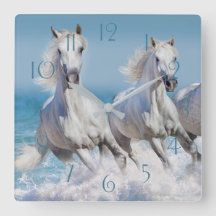 Andalusian white horses run in the waves