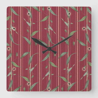 Horloge Carrée Branch of leaves on red wallpaper