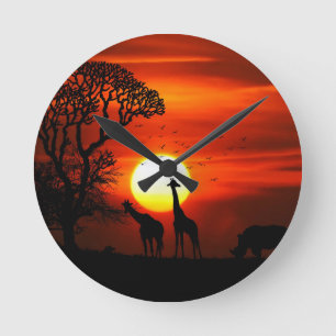 Horloge Ronde Coucher du soleil orange en silhouette de girafe