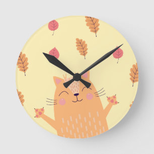 Horloge Ronde Joli chat orange roux jouant dans les feuilles d'a