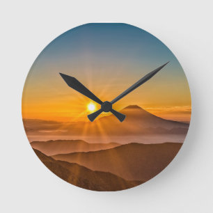 Horloge Ronde Lever de soleil entre les collines