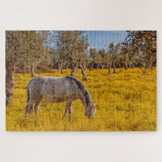 Horse grazing in a yellow flowers meadow jigsaw puzzle