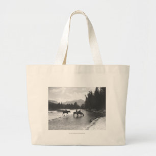 Horses drinking from and crossing a river large tote bag