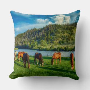 Horses Grazing Near A River And Mountain Throw Pillow