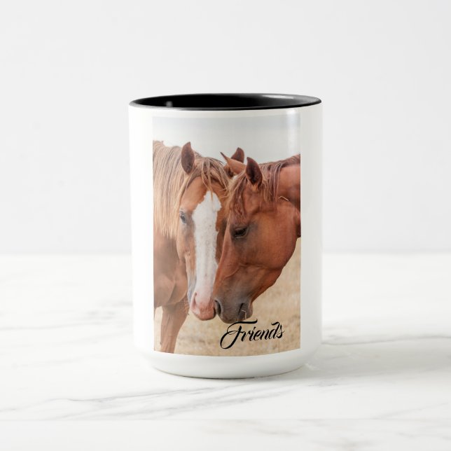 Horses nuzzling in a pasture mug (Center)