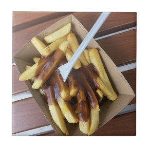 Hot chips drenched in gravy and chicken salt tile
