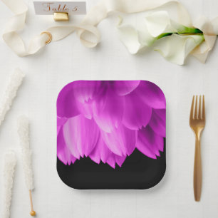 Hot pink flower petals on black paper plate