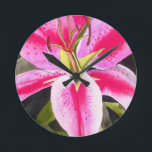 Hot pink lily Tenerife pop art watercolor flower Round Clock<br><div class="desc">with original design from watercolour painting by artist Sacha Grossel of hot pink lily flower in close up,  pop art macro style. This botanical inspired floral design is very bright and colourful with intense pink petals and green background.</div>