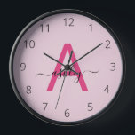Hot Pink Modern Script Girly Monogram Name Clock<br><div class="desc">A striking blend of style and functionality, this personalized clock features a bold, hot pink monogram set against a soft pink background, showcasing an elegant, handwritten script for the name. The minimalist design balances vibrant modernity with a touch of femininity, making it a standout piece for any room that calls...</div>