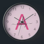 Hot Pink Modern Script Girly Monogram Name Clock<br><div class="desc">A striking blend of style and functionality, this personalized clock features a bold, hot pink monogram set against a soft pink background, showcasing an elegant, handwritten script for the name. The minimalist design balances vibrant modernity with a touch of femininity, making it a standout piece for any room that calls...</div>