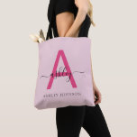 Hot Pink Modern Script Girly Monogram Name Tote Bag<br><div class="desc">Elevate your everyday style with this custom monogram tote bag. Featuring a striking hot pink letter “A” and elegant script that personalizes your name, this tote blends modern minimalism with a girly touch. Its spacious, durable design makes it the perfect accessory for any occasion—whether you’re running errands, heading to class,...</div>