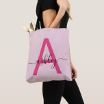 Hot Pink Modern Script Girly Monogram Name Tote Bag<br><div class="desc">Elevate your everyday style with this custom monogram tote bag. Featuring a striking hot pink letter “A” and elegant script that personalizes your name, this tote blends modern minimalism with a girly touch. Its spacious, durable design makes it the perfect accessory for any occasion—whether you’re running errands, heading to class,...</div>
