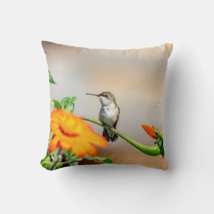 Hummingbird on a flowering plant throw pillow