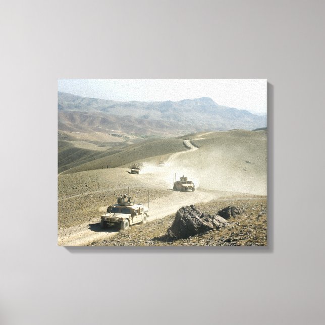 Humvees traverse rugged mountain roads canvas print (Front)